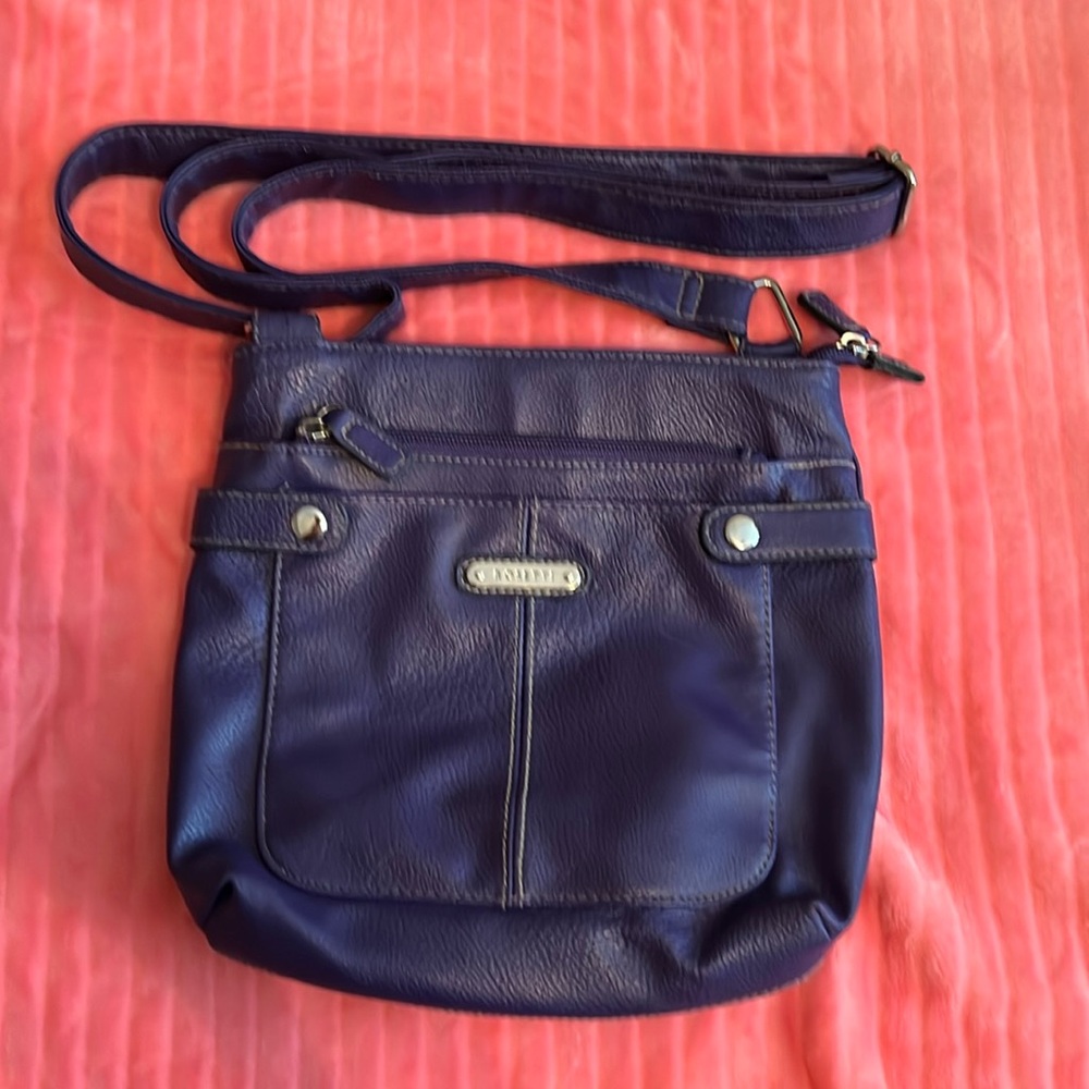 Purple Purse which is Rosetti Brand. The strap is adjustable.